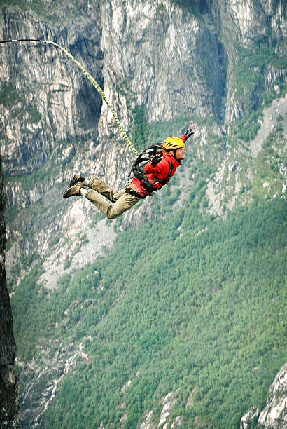 Jump rope. A man jumps from a cliff into the abyss. bungee jumping stock pictures, royalty-free photos & images