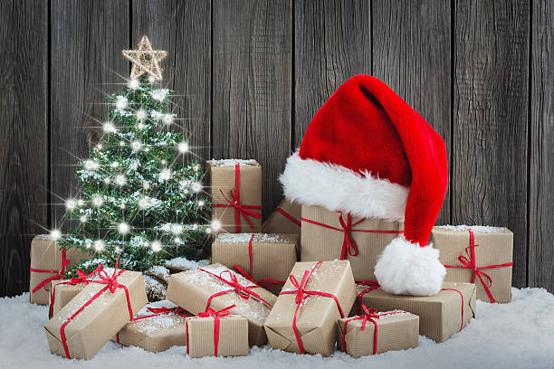 Vintage packages, Christmas tree and Santa Hat Vintage packages, Christmas tree and Santa Hat against the background of the old wooden boards christmas decoration storage stock pictures, royalty-free photos & images