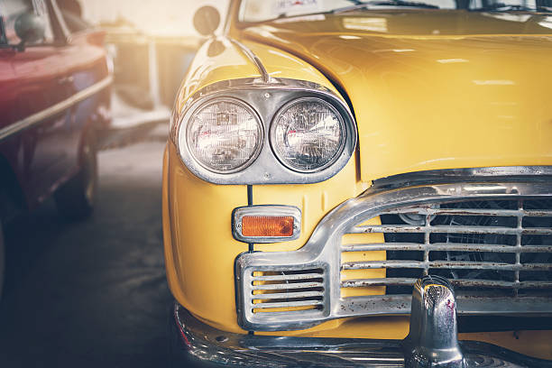 istock Close up headlight of yellow Retro classic car 618644910