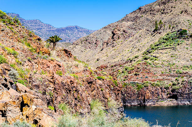 istock Red mountains, dark water and blue sky 618648318
