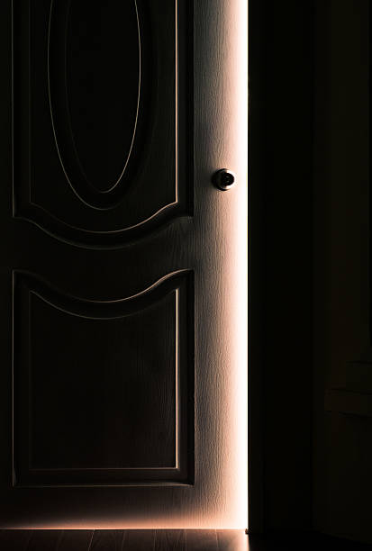 door opening in the dark room - targeted businessman beautiful male imagens e fotografias de stock