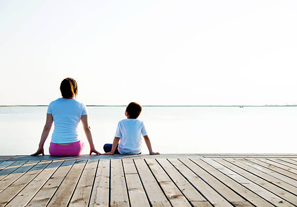 istock Mother with her son enjoying lake view 618649958