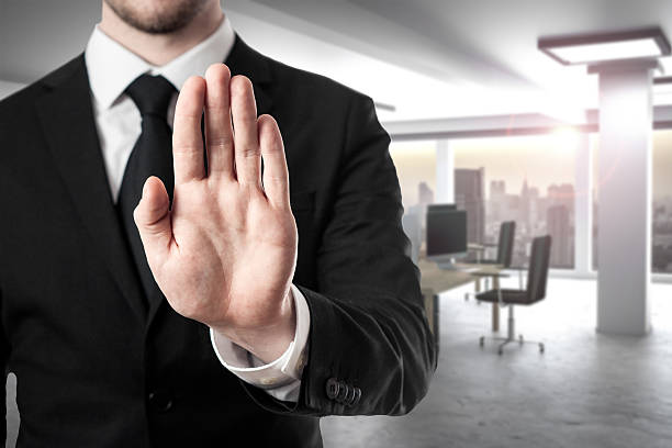 businessman in modern office hand stop gesture businessman in modern office room hand stop gesture single word no stock pictures, royalty-free photos & images