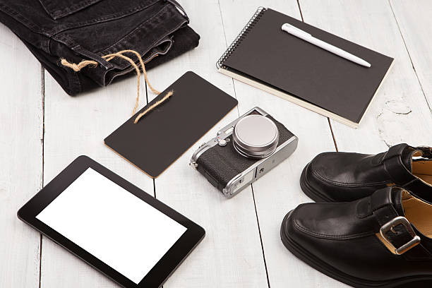 istock shoes, jeans, tablet pc, camera, notepad and chalkboard 618655532