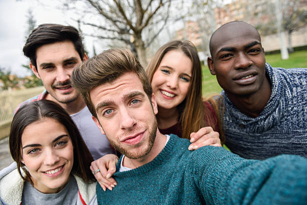 istock Multiracial group of friends taking selfie 618719104