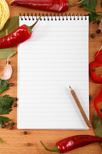 istock notebook for recipes, vegetables and spices on wooden table. 618719348