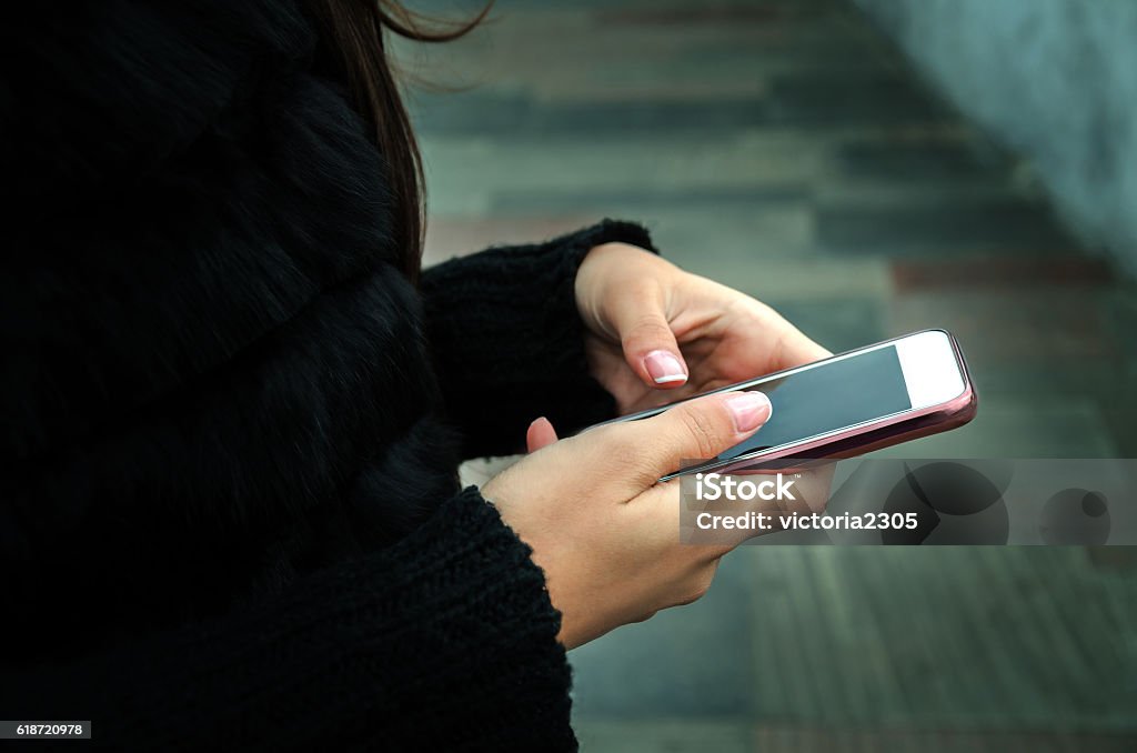 Modern communication systems young girl communicates with friends through social networks, together with a few people E-Mail Stock Photo