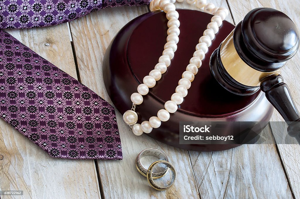 Divorce law concept. Judge gavel, rings, tie and pearl necklace Necklace Stock Photo