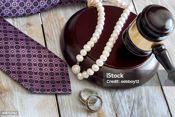 Divorce Law Concept Judge Gavel Rings Tie And Pearl Necklace Stock Photo - Download Image Now