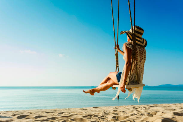 istock Woman at tropical swing 618722504