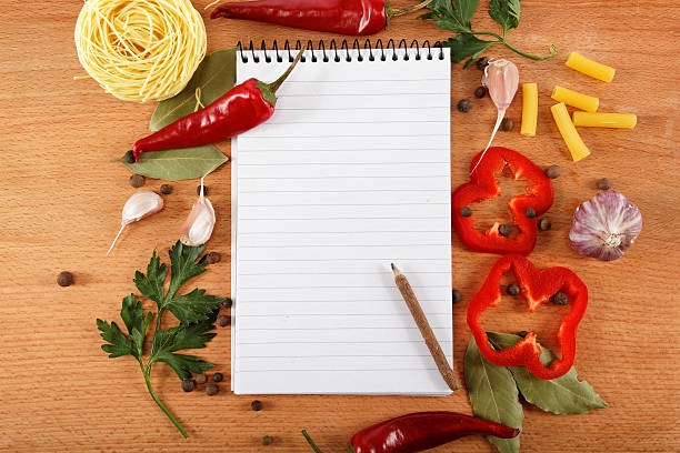 istock notebook for recipes, vegetables and spices on wooden table. 618722916