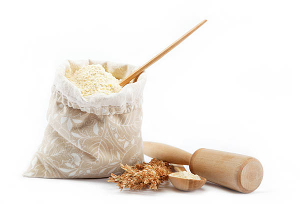 istock Corn flour in a bag with wooden spoon and ear 618723024