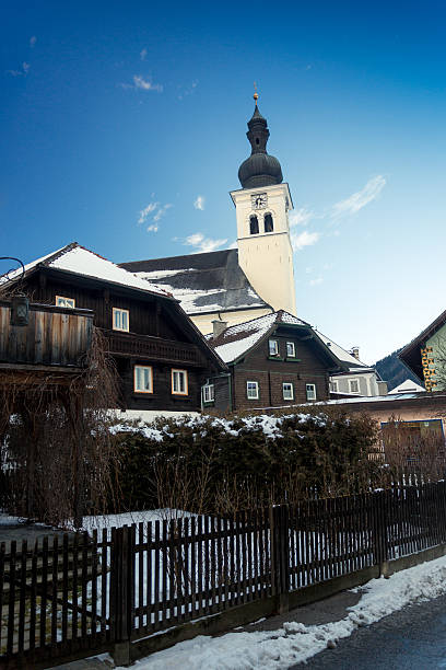 istock old catholic church at Austrian village covered by snow 618723038