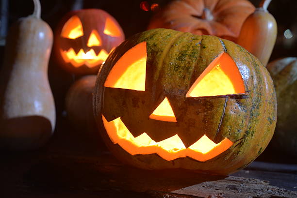 istock two halloween pumpkins jack faces with moonlight on top 618724792