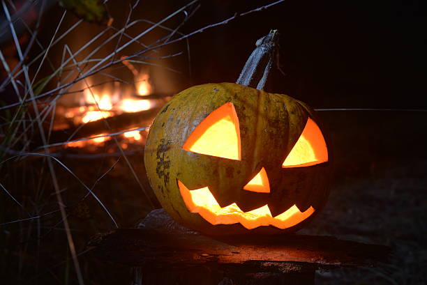 istock halloween pumpkin head jack with fire on the background 618724912