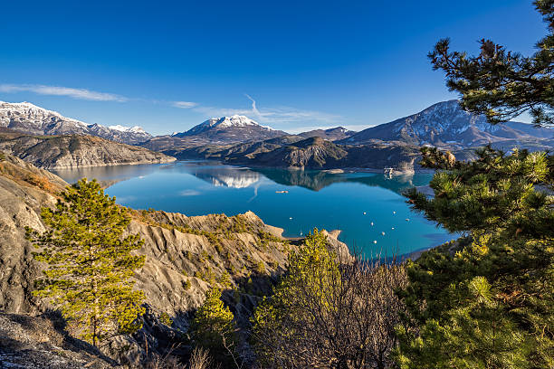 Serre Poncon Lake in Winter, Southern French Alps, France Serre Poncon Lake from Le Rousset with Winter view on Saint Vincent Les Fort and Le Sauze du Lac. A peaceful area in Hautes Alpes, the Southern French Alps. France alpes de haute provence photos stock pictures, royalty-free photos & images