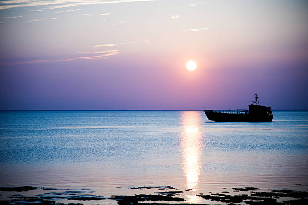 istock Silhouette of cargo ship sailing on sea 618726884