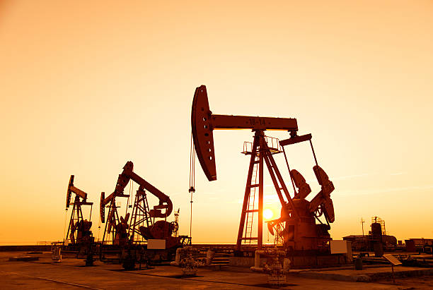 istock Oil pumps and rig at sunset 618727540