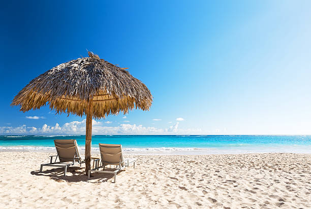 istock Beach chairs with umbrella and beautiful sand beach 618727920