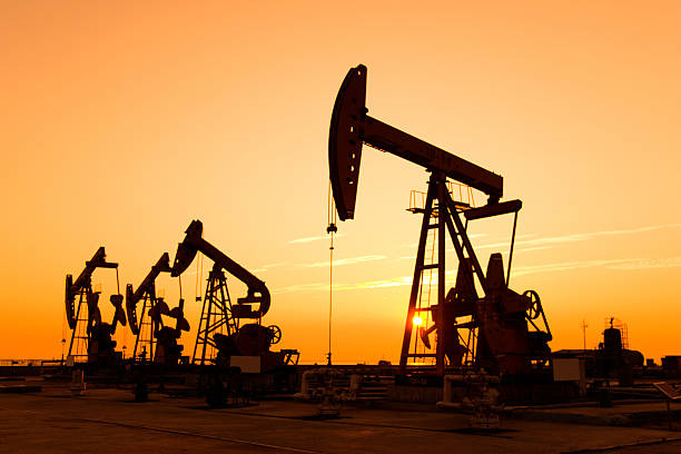 istock Oil pumps and rig at sunset 618728062