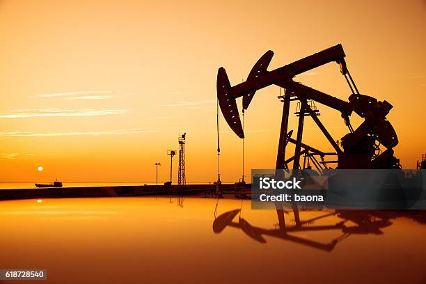Oil Pumps And Rig At Sunset Stock Photo - Download Image Now - Crude Oil, Sea, Mining - Natural Resources