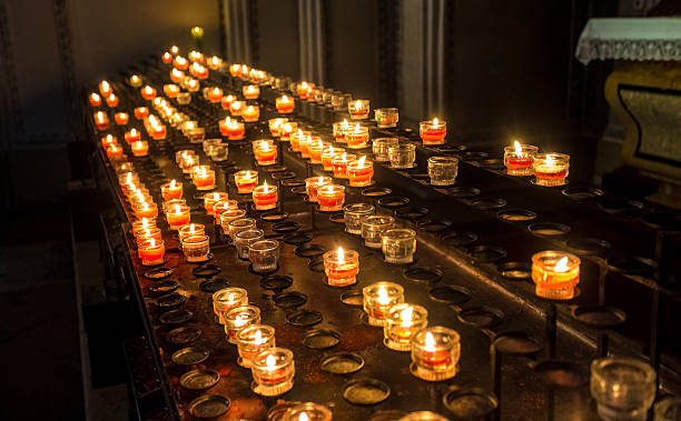 istock red candle lights at altar in cathedral 618728624