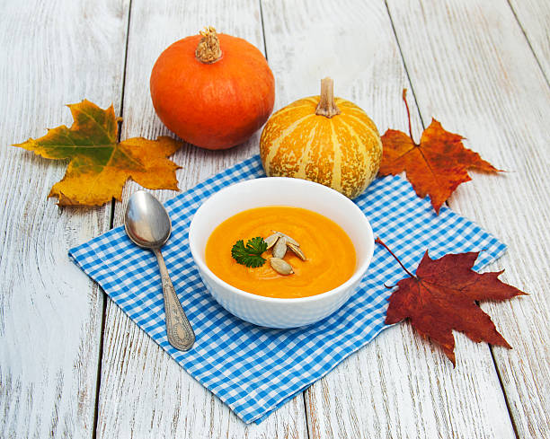 istock Pumpkin soup with fresh pumpkins 618729044