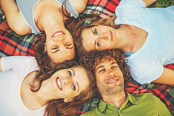 istock Young people resting in nature, lying on grass 618729222