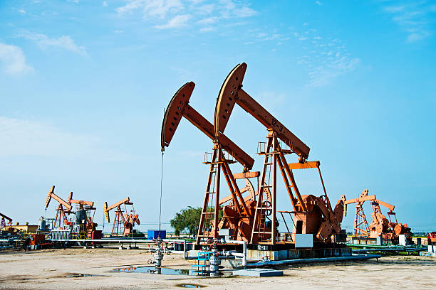 istock Oil pumps and rig in a field 618729644