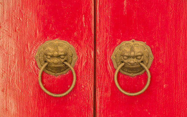 istock Bronze nandle on red door 618730988