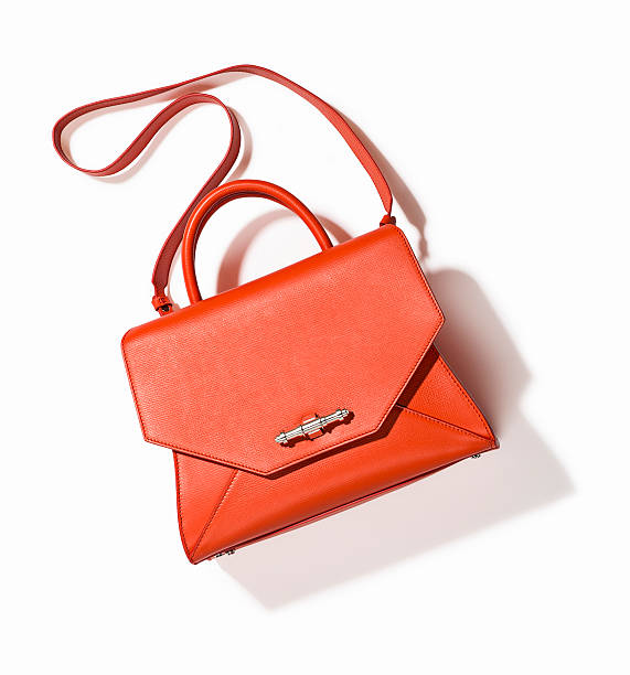 orange handbag A fashionable women handbag isolated on white background ( with clipping path) purse photos stock pictures, royalty-free photos & images