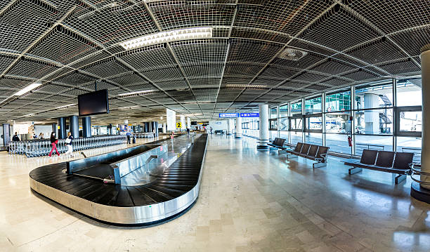 people at baggage belt inside the new terminal Marseilles, France - August 19, 2016: people at baggage belt inside the new terminal at airport of Marseilles, France. marseille station stock pictures, royalty-free photos & images