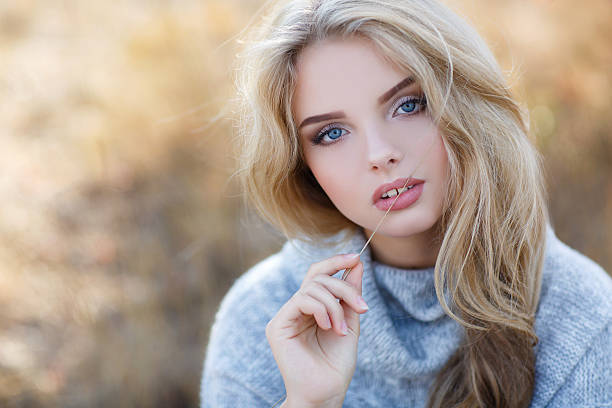 istock Beautiful woman in autumn park 618737038