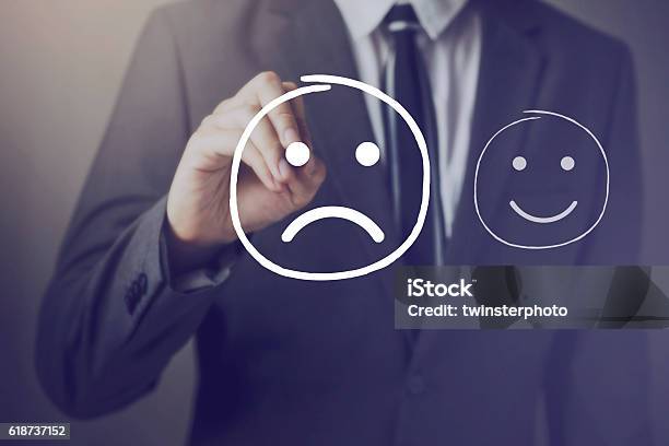 Customer Choosing To Write Unhappy Face Over Happy Face Stock Photo - Download Image Now