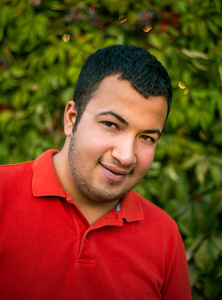 istock Portrait of smiling young man against trees 618737334