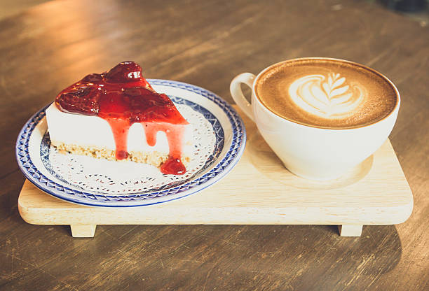 istock strawberry  cheese cake    and latte coffee  on wood table 618738794