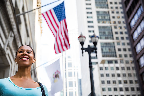 Young woman in Downtown Chicago having shopping, cycling and using social media walking through the office.