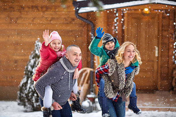 istock smiling family enjoying on winter holiday 618740116