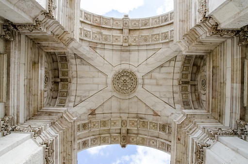 Details of Augusta Street Arch seen from below at Commerce Square in Lisbon during daytime in Autumn with cloudy sky.