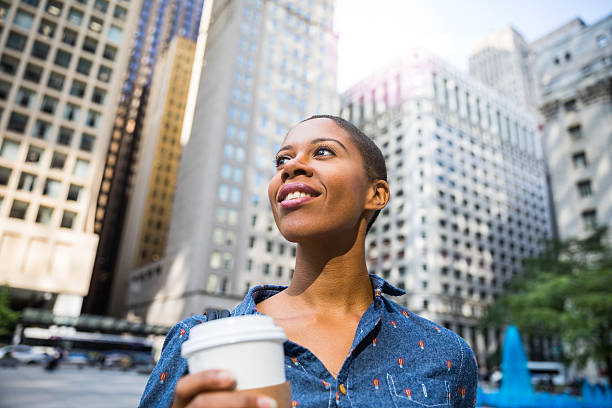Woman having a break in city downtown drinking a coffee