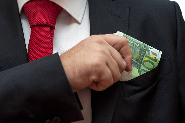 istock Businessman putting money in his pocket 618741550