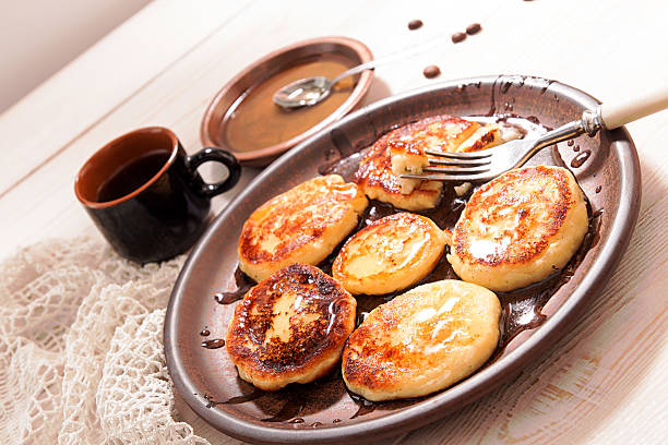 istock Cottage cheese pancakes with honey on brown ceramic plate 618742352