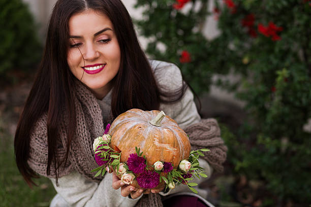 istock Woman holding a pumpkin 618744454