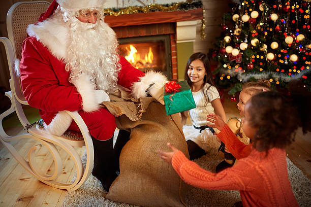 istock Santa Claus gives presents 618746862