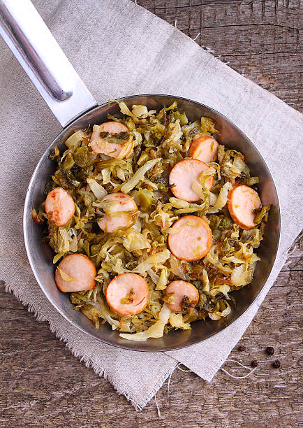 istock Cabbage stew with sausages in a frying pan 618747046