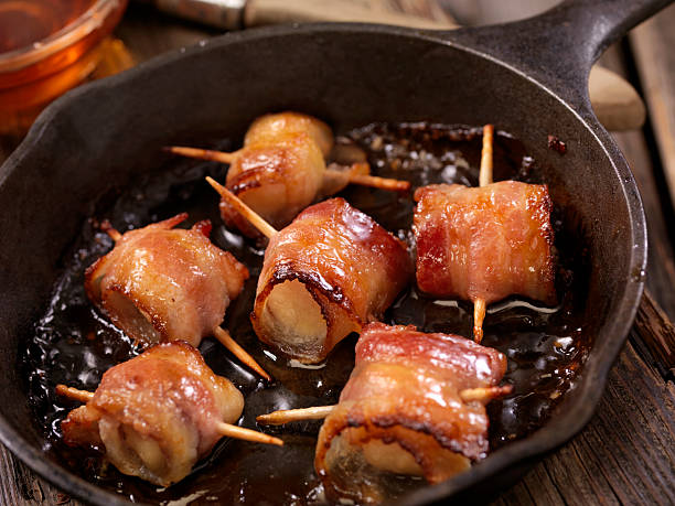 Bacon Wrapped Scallops in a Maple Glaze Grilled Bacon Wrapped Scallops in a Maple Glaze - Photographed on Hasselblad H3D2-39mb Camera bacon wrapped stock pictures, royalty-free photos & images