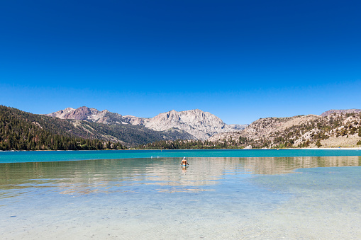 Majestic Tenaya Lake in Yosemite's Tuolumne Meadows is a fantastic spot for a swim during the hot summer months. The surrounding granite peaks and crystal clear water are a sight to behold.