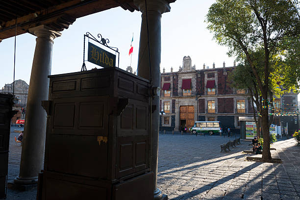 Mexico City, Mexico - October 29, 2014: Early morning scene with people at Plaza Santo Domingo in the Centro Historico area of Mexico City, Mexico.