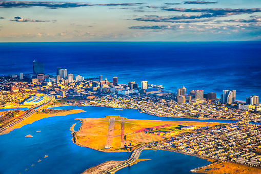  Aerial view of Atlantic City taken from an airplane. It is a beautiful sunny day with high clouds. The shot taken with a Canon 5D Mark iV shows bright blue Atlantic ocean and bay.