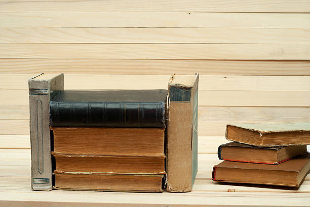 istock Stack of hardback books on wooden table. Back to school 618748690